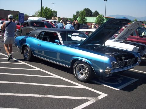 1972 Ford Ranchero - Blue classic car with hood open at an outdoor event. Multiple vehicles are present.