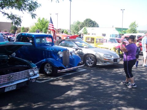 1972 Ford Ranchero - Several cars are parked at an outdoor event, including a blue hot rod truck and a silver convertible.