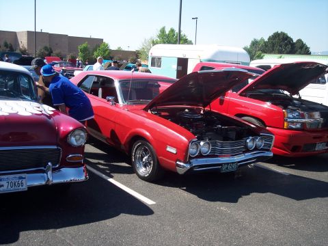 1972 Ford Ranchero - Several vehicles are displayed with their hoods open at an outdoor event under a clear sky.