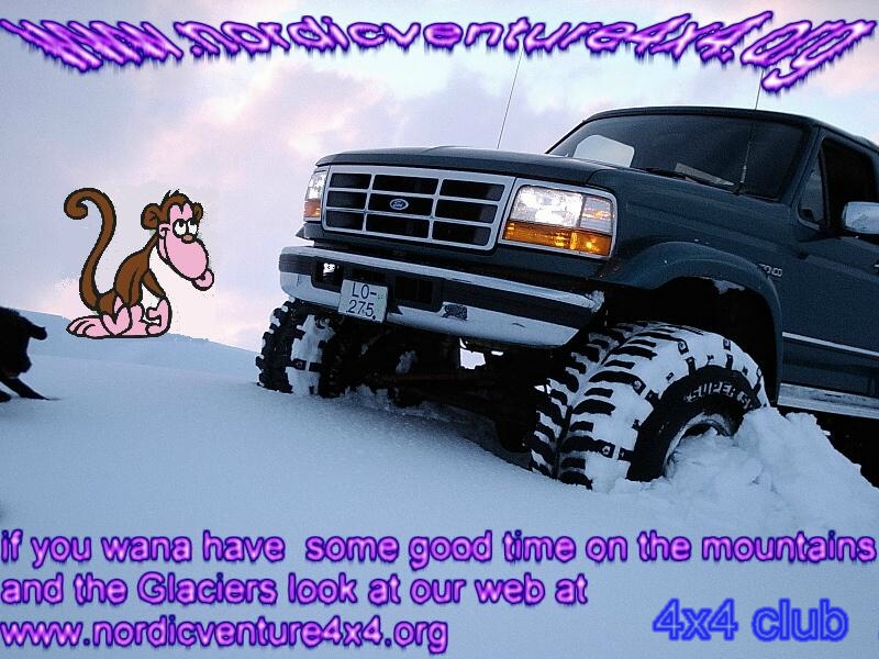 Dark green lifted Ford SUV on big tires in deep snow with 4x4 club promo text