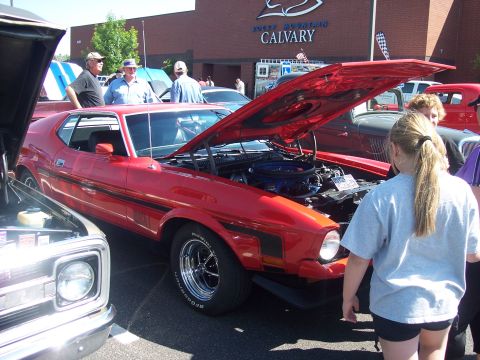 1972 Ford Ranchero - A red 1972 Ford Ranchero is displayed with its hood open at an outdoor car show.