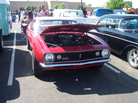 1972 Ford Ranchero - A red 1969 Chevrolet Camaro is parked with its hood open, showing the engine.