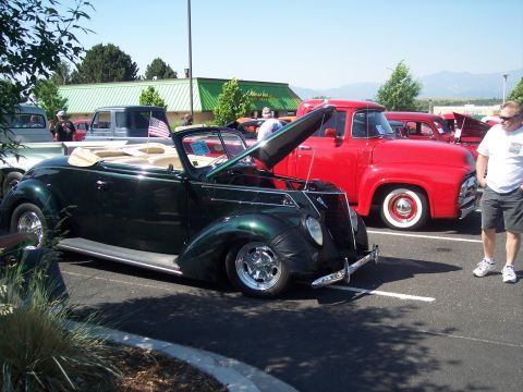 1972 Ford Ranchero - Two classic Ford vehicles, a convertible and a pickup truck, displayed at an outdoor event.