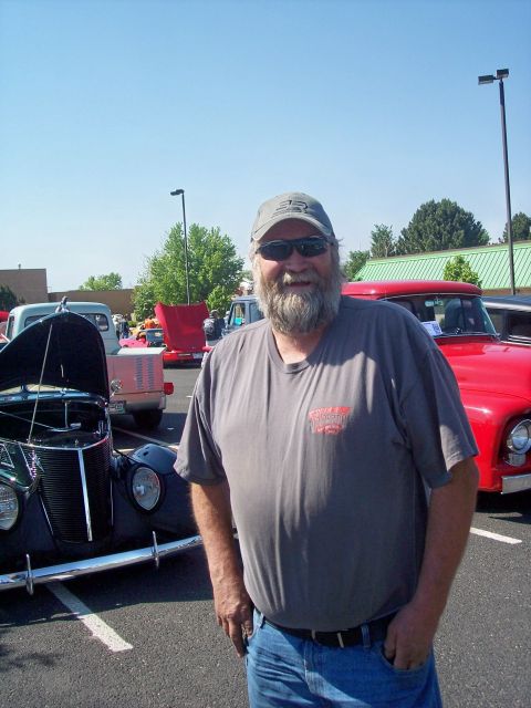 1972 Ford Ranchero - A man poses for a photo at an outdoor car show with several vintage vehicles visible.