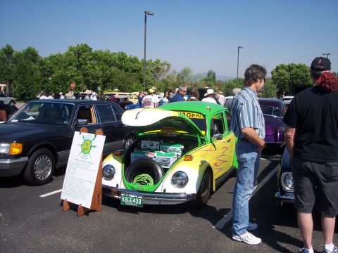 1972 Ford Ranchero - Modified Volkswagen Beetle with electric conversion and custom paint at a car show.