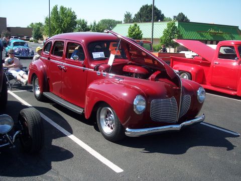 1972 Ford Ranchero - A classic red sedan from the 1940s is displayed with its hood open, revealing the engine.