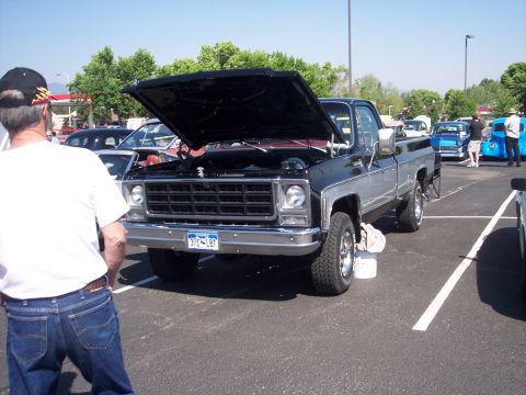 1972 Ford Ranchero - A black and silver pickup truck is displayed with its hood open at an outdoor event.