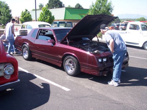 1972 Ford Ranchero - Maroon 1981 Chevrolet Monte Carlo at an outdoor car show with hood up.
