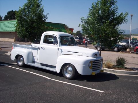 1972 Ford Ranchero - A classic white pickup truck is parked in a lot on a sunny day.