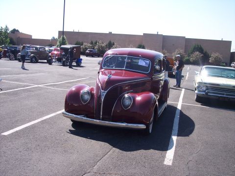 1972 Ford Ranchero - A maroon 1939 Ford Coupe is parked in a lot, with a paper visible on its windshield.