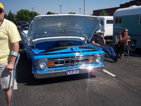 1972 Ford Ranchero - A blue pickup truck with its hood open sits on display, showing off its engine bay.