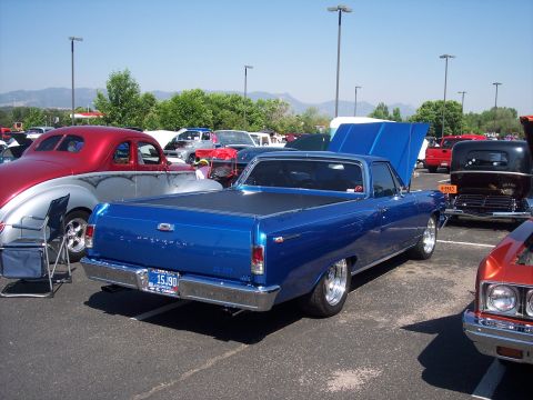 1972 Ford Ranchero - Blue 1967 Chevrolet El Camino at a car show, other vehicles visible in the background.