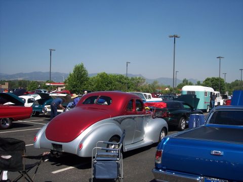 1972 Ford Ranchero - A two-tone hot rod is displayed at an outdoor event with several other vehicles present.