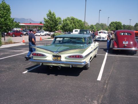 1972 Ford Ranchero - A classic 1959 Chevrolet Impala is parked in a lot with other vintage vehicles on a sunny day.