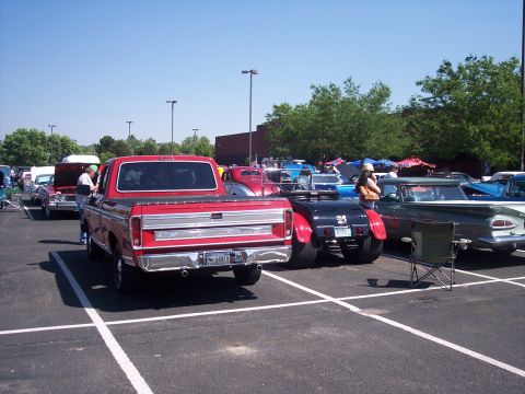 1972 Ford Ranchero - Red 1979 Ford F-150 pickup truck at a car show with multiple other vehicles.