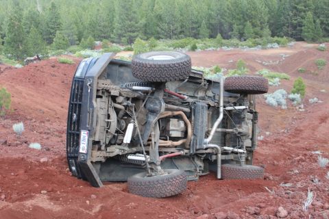 1995 Ford Bronco - This 1995 Ford Bronco has rolled over and is resting on its side in a rural, dusty environment.