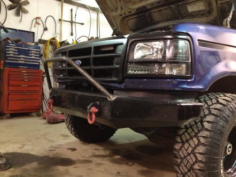 1996 Ford Bronco - A blue Ford F-Series truck is parked in a garage with its hood up and a custom bumper installed.