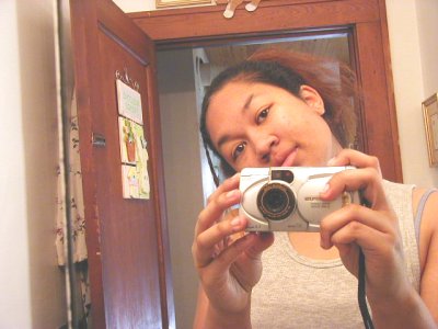 1997 Ford Taurus - A woman takes a selfie in a bathroom mirror while holding a digital camera.