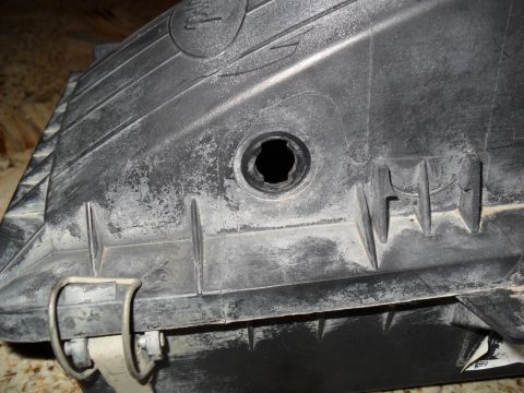 1990 Ford Bronco - Close-up of a black plastic mass air sensor housing, showing its textured surface and mounting clips.