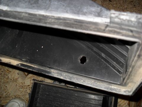 1990 Ford Bronco - This is a close-up view of a car part, possibly an air intake component.