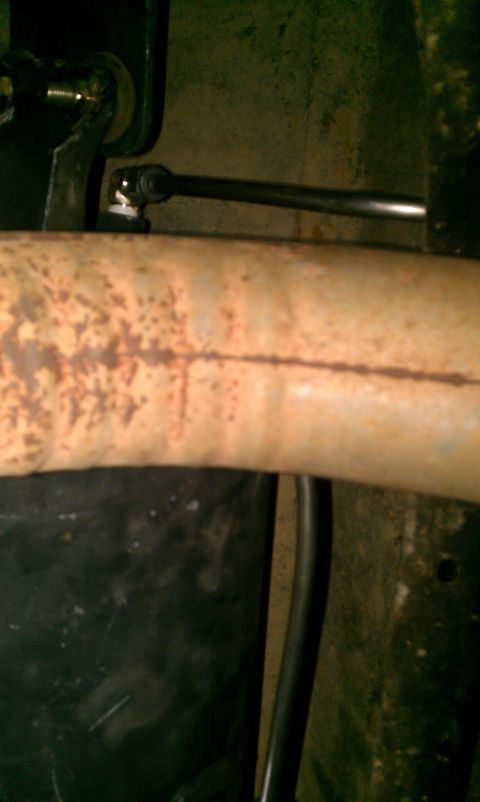 1995 Ford Bronco - Exhaust pipe and linkage detail, likely from the underside of a vehicle.