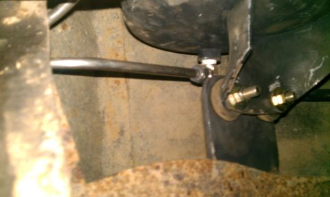 1995 Ford Bronco - Underside view of an air compressor tank with associated plumbing and mounting hardware.