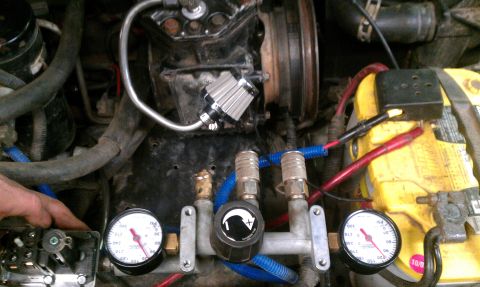 1995 Ford Bronco - Close-up view of an on-board air compressor system, gauges and quick disconnect fittings.