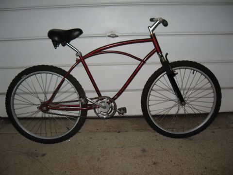 1994 Ford Bronco - A side view of a red cruiser bicycle with thick tires and a curved frame.