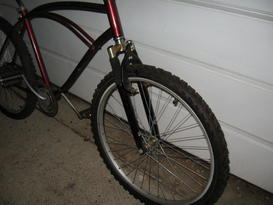 Bicycle frame with front wheel and suspension fork, dark red and black