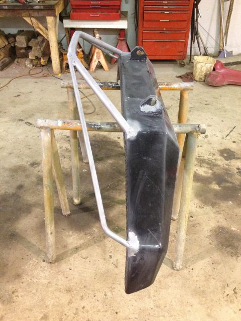 1996 Ford Bronco - Custom off-road bumper with brush guard is being worked on in a garage.