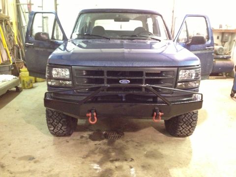 1996 Ford Bronco - Front view of a blue 1996 Ford Bronco, an aftermarket bumper and open doors.