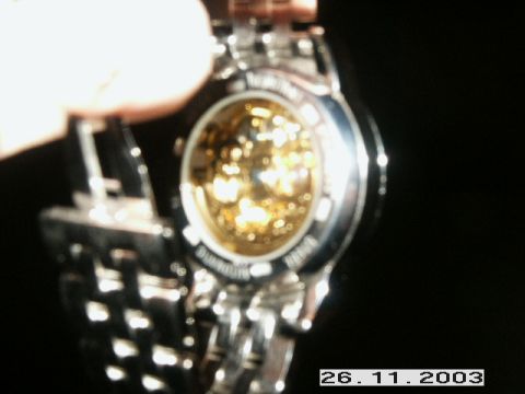 1998 Mercury Sable - A mechanical watch is shown with its intricate internal workings exposed through a transparent case back.