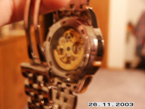 1998 Mercury Sable - The intricate mechanical workings of a watch movement are displayed through a transparent case back.
