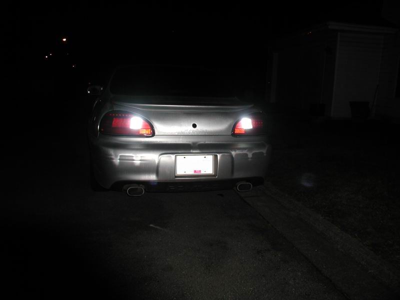 2002 Pontiac Grand Prix rear view, silver, with illuminated backup lights and dual exhaust tips