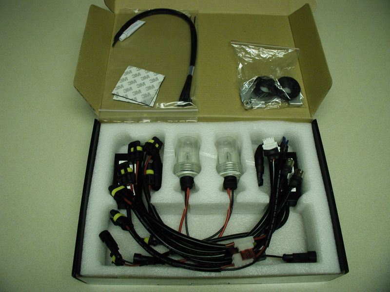 Boxed HID conversion kit with two bulbs, wiring harnesses, and 3M adhesive pads