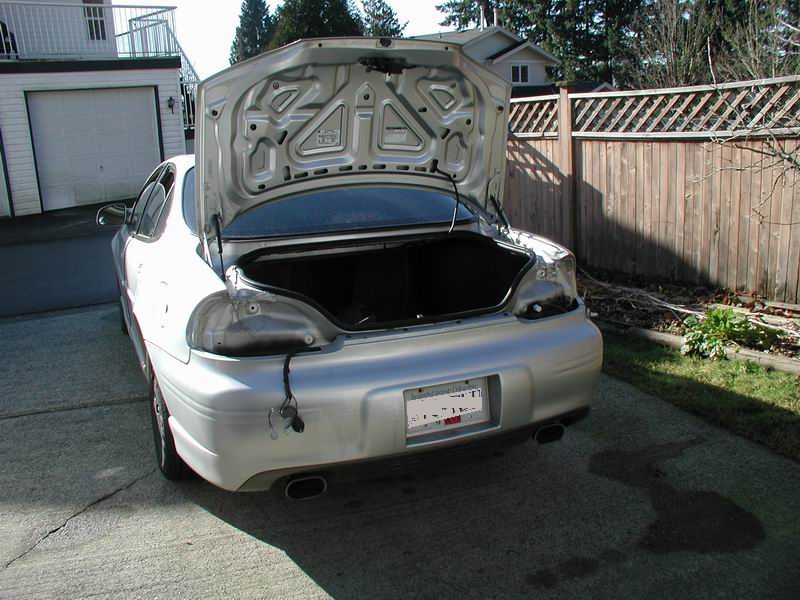 Silver 2002 Pontiac Grand Prix rear with trunk open and damaged taillight