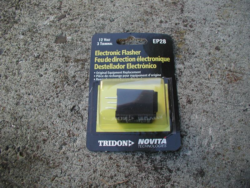Electronic flasher part in packaging, labeled 12 Volt 3 Terminal, EP28, Tridon Novita Technologies