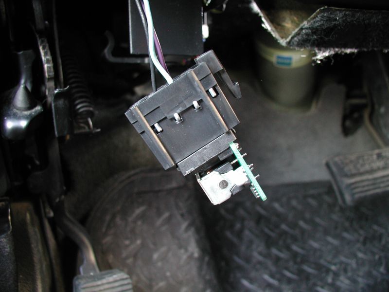 Headlight or dimmer switch connector removed under vehicle dashboard