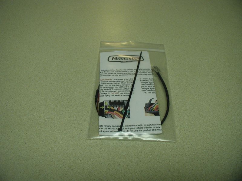 Radar detector wiring harness and instructions in a plastic bag