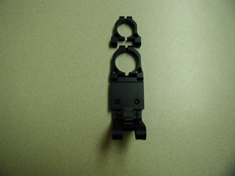 Black radar detector mount with two rings on a speckled surface