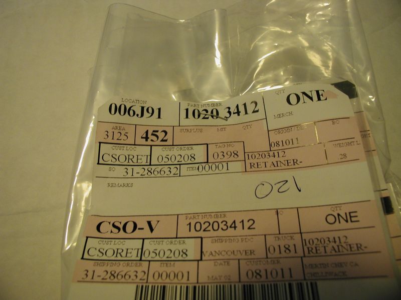 Part in plastic packaging with shipping labels showing part number 10203412