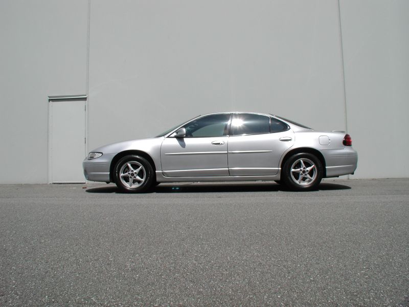 Silver 2002 Pontiac Grand Prix sedan parked outside