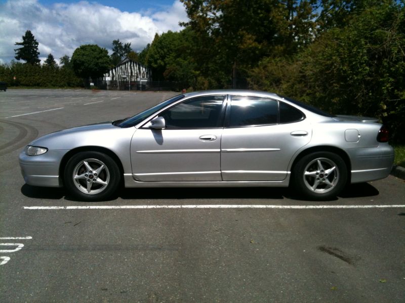 2002 Pontiac Grand Prix sedan, silver, parked in a lot