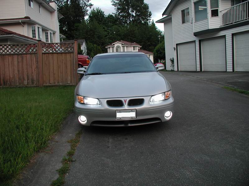 Silver 2002 Pontiac Grand Prix sedan parked in driveway, front view