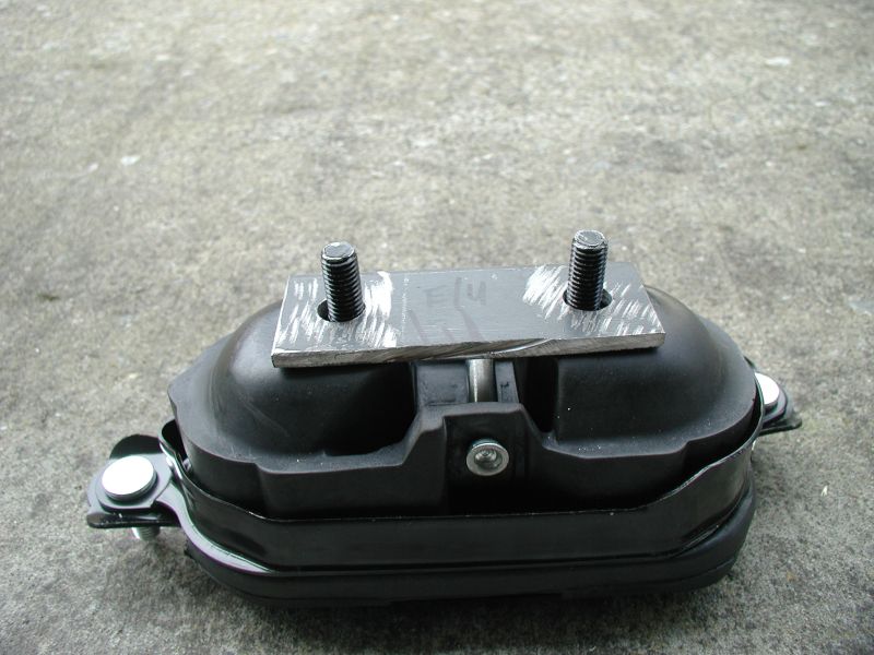 Engine mount with two bolts on a metal plate