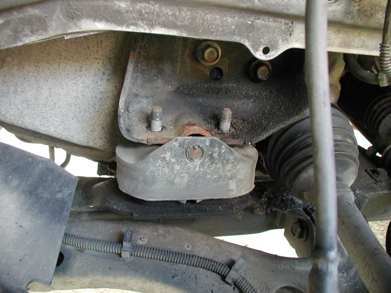 Close-up of a vehicle's engine mount and suspension components