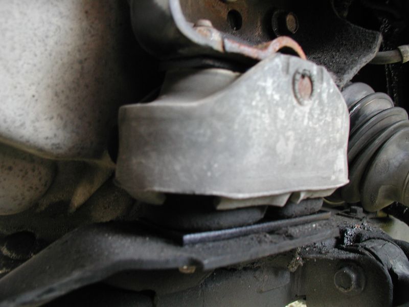 Close-up of a vehicle's engine mount with rubber and metal components