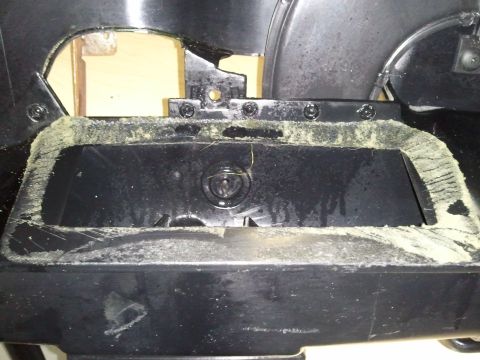 1994 Ford Bronco - Close-up of a dusty black dashboard section with a central circular component.