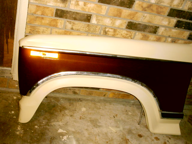 Two-tone fender, brown and cream, with amber turn signal and chrome trim
