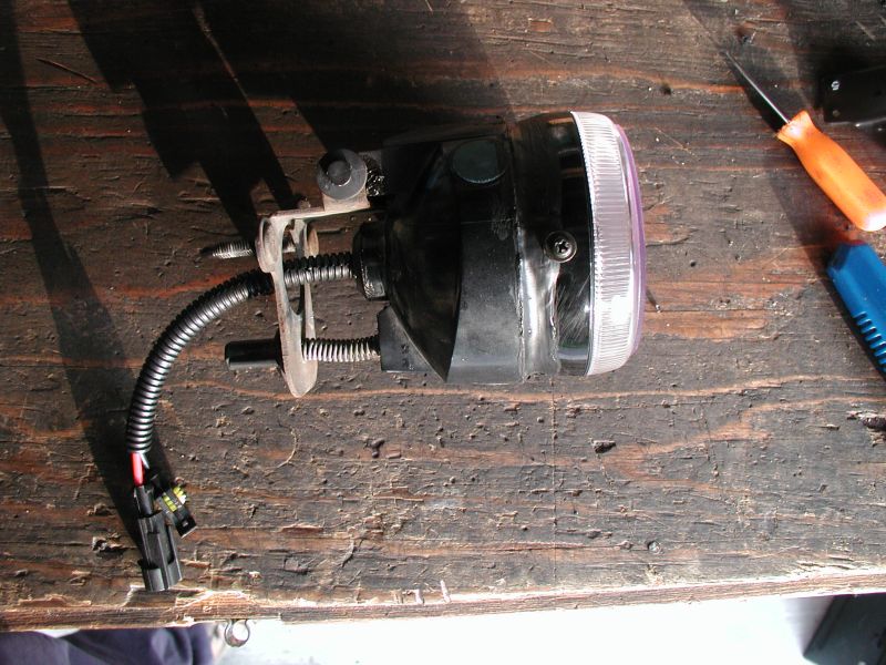 aftermarket fog light assembly with mounting bracket and wiring harness
